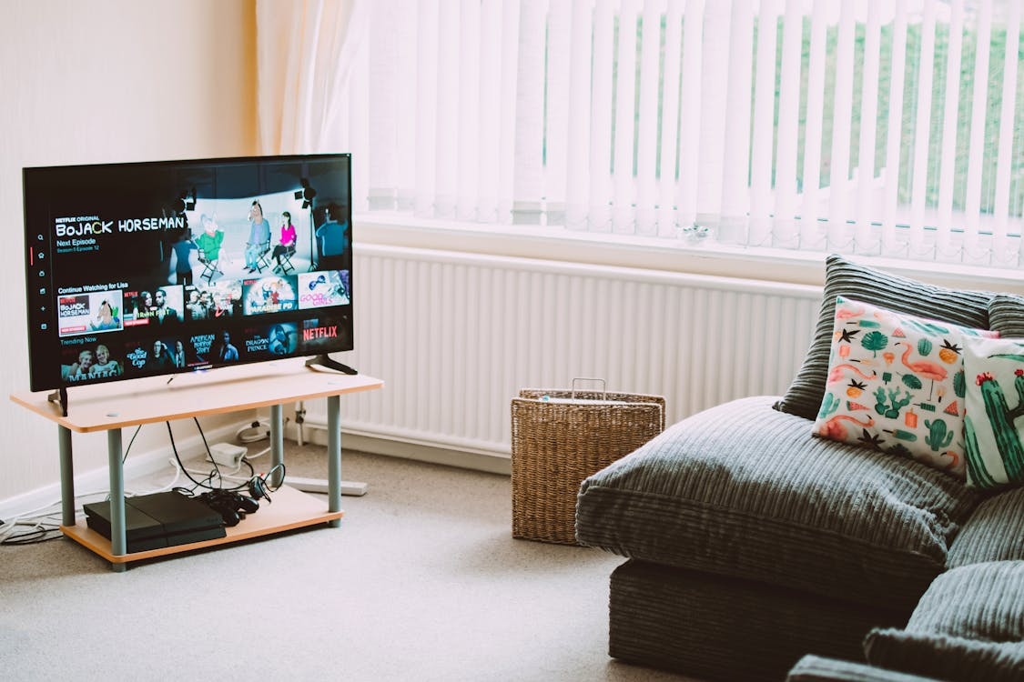 Living room TV showing streaming apps for a whole-home streaming system setup.