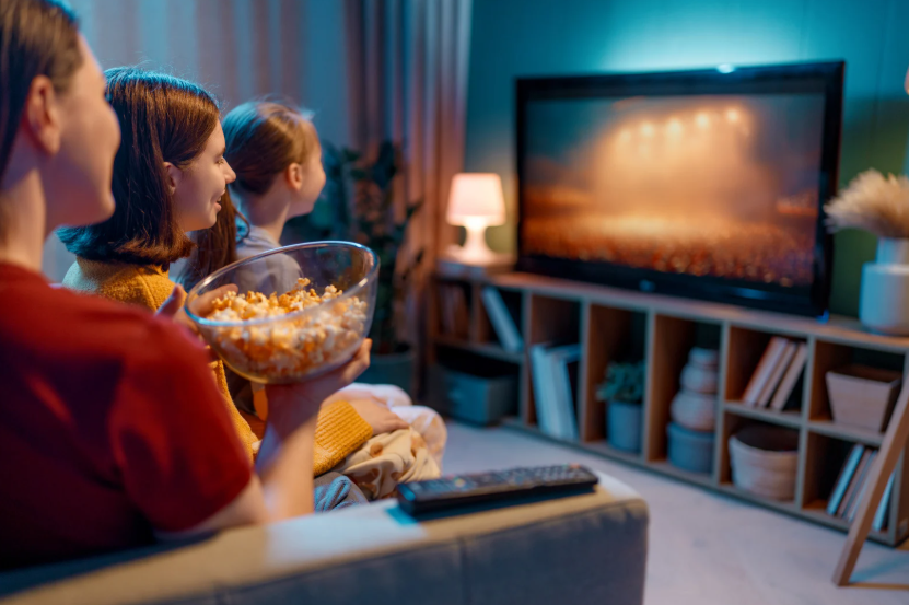 Family using streaming services for classic TV to watch comfort shows together.