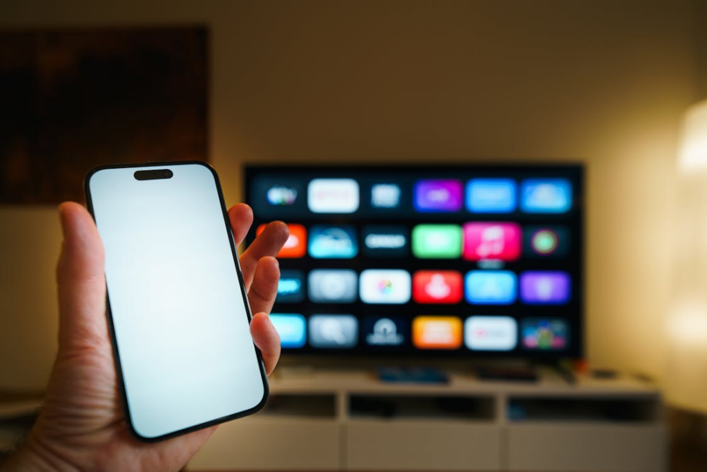 Phone and TV showing streaming apps with viewer deciding which streaming services to keep or cancel.