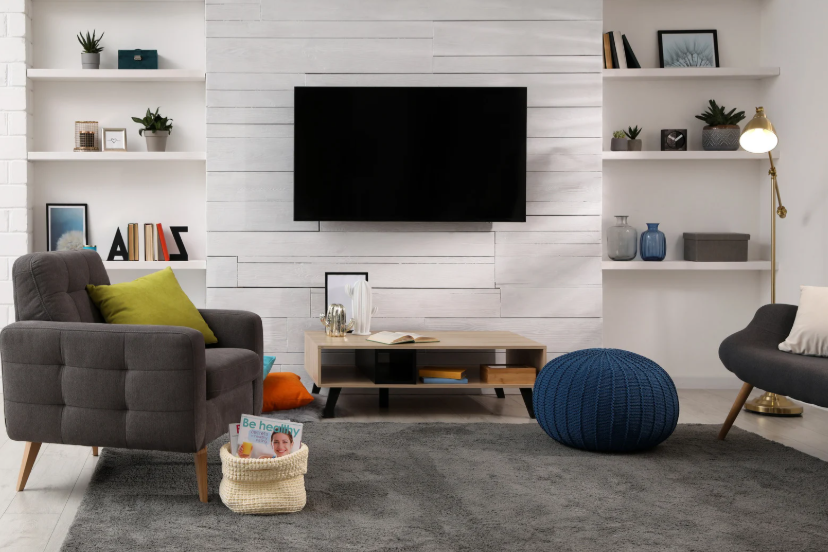 Wall-mounted TV in a small apartment living room with a clean streaming setup.